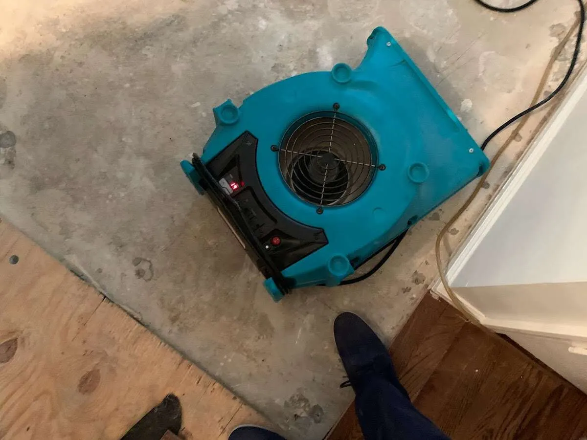 Air mover drying subfloor during Commercial Water Damage Restoration in Hastings